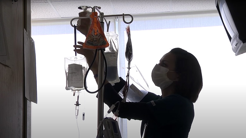 Bone marrow transplant nurse sets up intravenous medication bag